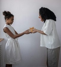 a mum giving her daughter a present in a quiet place, no decorations