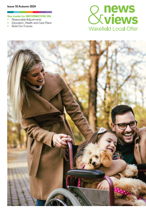 parents pushing child in wheelchair through autumn leaves