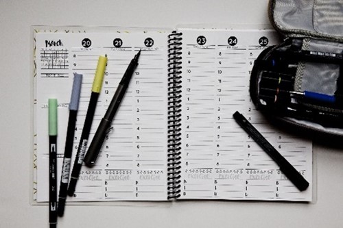 calendar in diary with coloured pens