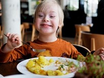 a child eating food looking happy